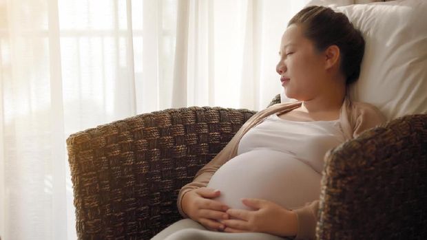 Asian pregnant woman sleepingon the sofa