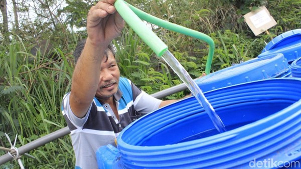 Warga menampung air dari slang PDAM. (Foto: Yudha Maulana/detikcom)