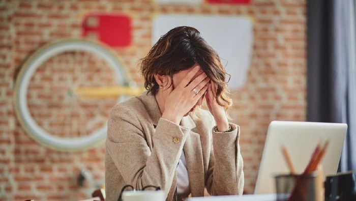 zodiak business woman feel depress and use smart phone while drinking coffee in the office