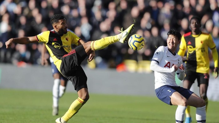 Watfords Troy Deeney, left, challenges for the ball with Tottenhams Son Heung-min during the English Premier League soccer match between Watford and Tottenham Hotspur at Vicarage Road, Watford, England, Saturday, Jan. 18, 2020. (AP Photo/Frank Augstein)