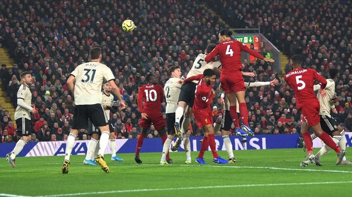 LIVERPOOL, ENGLAND - JANUARY 19: Virgil van Dijk of Liverpool scores his teams first goal during the Premier League match between Liverpool FC and Manchester United at Anfield on January 19, 2020 in Liverpool, United Kingdom. (Photo by Michael Regan/Getty Images)