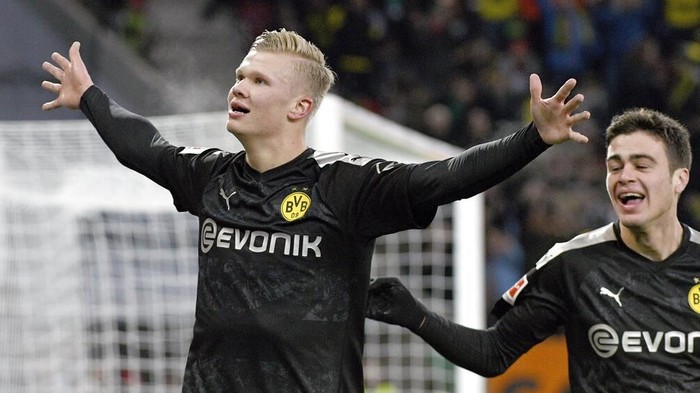Dortmunds Erling Haaland celebrates after scoring his third goal of the game during the German Bundesliga soccer match between Borussia Dortmund FC Augsburg at the WWK Arena in Augsburg, Germany, Saturday, Jan. 18, 2020. (Tom Weller/dpa via AP)