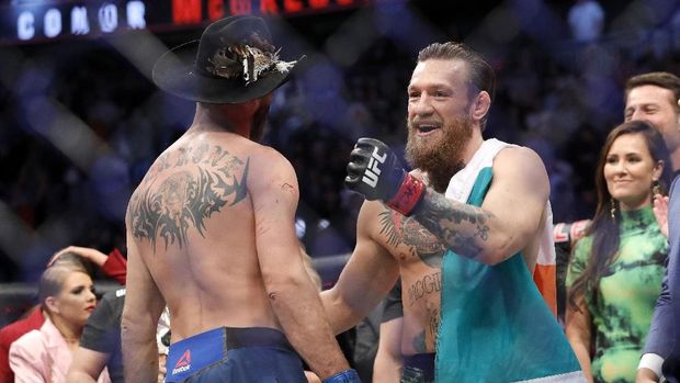 LAS VEGAS, NEVADA - JANUARY 18: Conor McGregor hugs Donald Cerrone after his first round TKO victory in their welterweight bout during UFC246 at T-Mobile Arena on January 18, 2020 in Las Vegas, Nevada. Steve Marcus/Getty Images/AFP