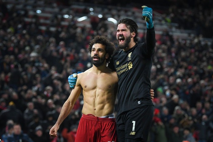 LIVERPOOL, ENGLAND - JANUARY 19: Mohamed Salah of Liverpool celebrates his goal to make it 2-0 with Alisson Becker during the Premier League match between Liverpool FC and Manchester United at Anfield on January 19, 2020 in Liverpool, United Kingdom. (Photo by Michael Regan/Getty Images)