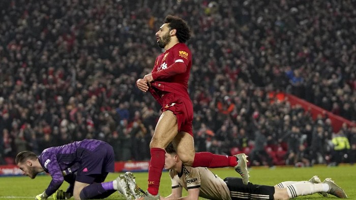 Liverpools Mohamed Salah, centre, celebrates after scoring his sides second goal during the English Premier League soccer match between Liverpool and Manchester United at Anfield Stadium in Liverpool, Sunday, Jan. 19, 2020.(AP Photo/Jon Super)
