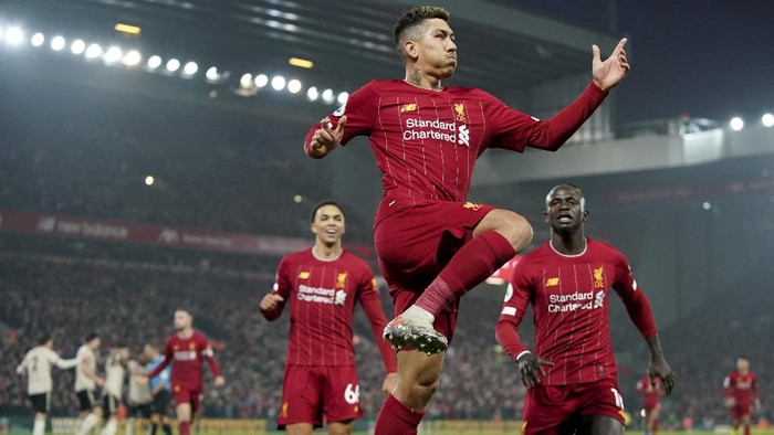 Liverpools Roberto Firmino celebrates after a disallowed goal during the English Premier League soccer match between Liverpool and Manchester United at Anfield Stadium in Liverpool, Sunday, Jan. 19, 2020.(AP Photo/Jon Super)