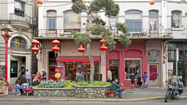 Chinatown Vancouver Victoria Island, Vancouver, B.C., Canada. Chinatown street scene with lanterns and coloured decoration amidst hanging baskets of flowers and traditional architecture in the old town city centre, Victoria, Victoria Harbour, Vancouver, B.C., Canada