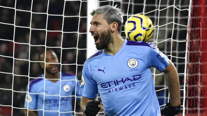Manchester Citys Sergio Aguero celebrates after scoring his sides opening goal during the English Premier League soccer match between Sheffield United and Manchester City at Bramall Lane in Sheffield, England, Tuesday, Jan. 21, 2020. (AP Photo/Rui Vieira)