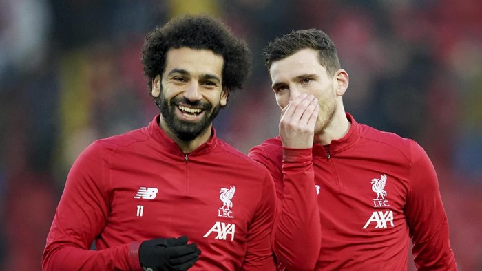 Liverpools Mohamed Salah, left, and Liverpools Andrew Robertson warm up before the English Premier League soccer match between Liverpool and Manchester United at Anfield Stadium in Liverpool, Sunday, Jan. 19, 2020.(AP Photo/Jon Super)
