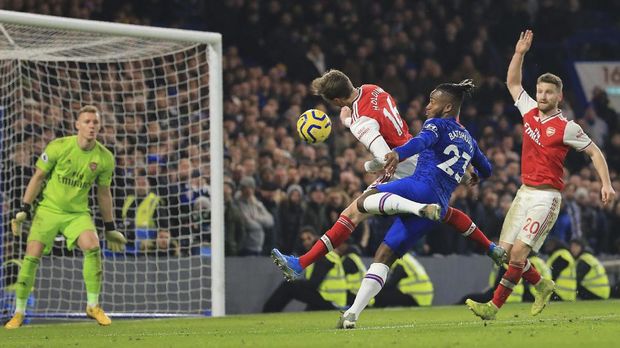 Chelsea's Michy Batshuayi, center right, fights for the ball with Arsenal's Rob Holding during the English Premier League soccer match between Chelsea and Arsenal at Stamford Bridge stadium in London England, Tuesday, Jan. 21, 2020. (AP Photo/Leila Coker)