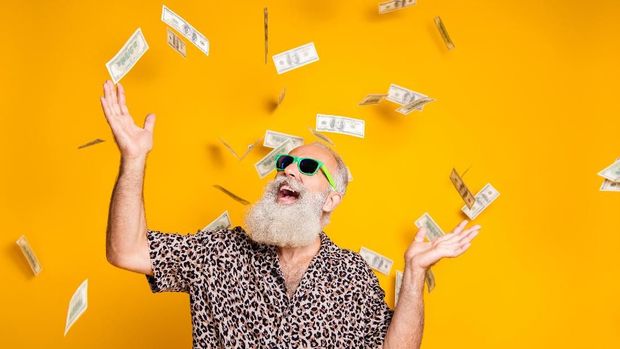 Portrait of crazy funky funny old bearded man hipster in green eyeglasses, eyewear look up at money falling scream great win lottery wear leopard stylish shirt isolated over yellow background
