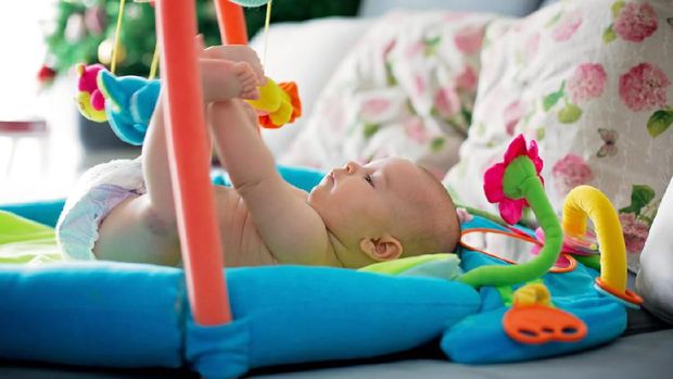 Little baby boy, playing with colorful toys at home, newborn baby activity, coordination and development