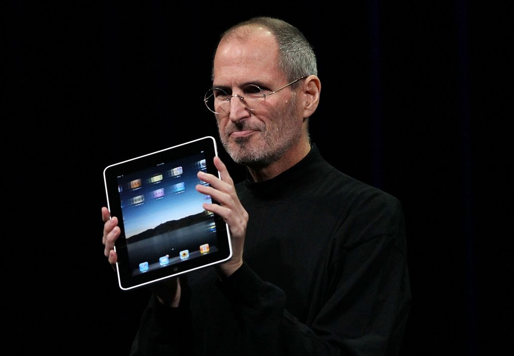 SAN FRANCISCO - JANUARY 27: Apple Inc. CEO Steve Jobs holds up the new iPad as he speaks during an Apple Special Event at Yerba Buena Center for the Arts January 27, 2010 in San Francisco, California. Apple introduced its latest creation, the iPad, a mobile tablet browsing device that is a cross between the iPhone and a MacBook laptop. (Photo by Justin Sullivan/Getty Images)
