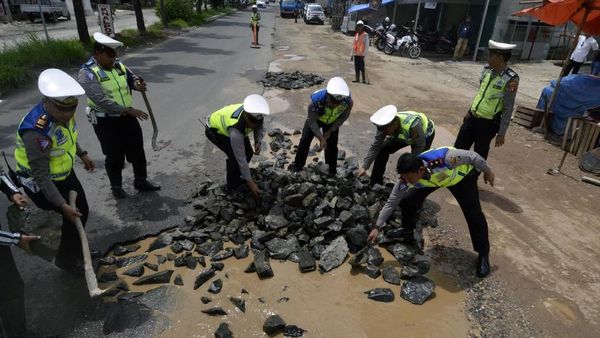 Ketika Personel Polresta Bandar Lampung Perbaiki Jalan Rusak