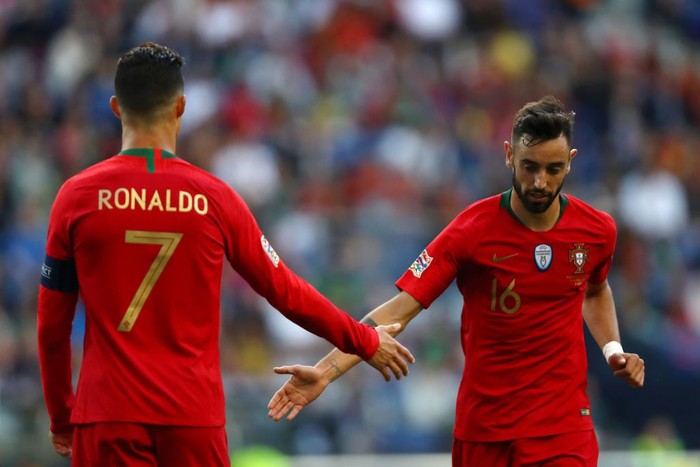 1154836249 PORTO, PORTUGAL - JUNE 09: Cristiano Ronaldo of Portugal speaks with Bruno Fernandes of Portugal during the UEFA Nations League Final between Portugal and the Netherlands at Estadio do Dragao on June 09, 2019 in Porto, Portugal. (Photo by Dean Mouhtaropoulos/Getty Images)