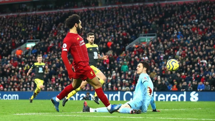 LIVERPOOL, ENGLAND - FEBRUARY 01: Mohamed Salah of Liverpool scores his teams third goal past Alex McCarthy of Southampton during the Premier League match between Liverpool FC and Southampton FC at Anfield on February 01, 2020 in Liverpool, United Kingdom. (Photo by Julian Finney/Getty Images)