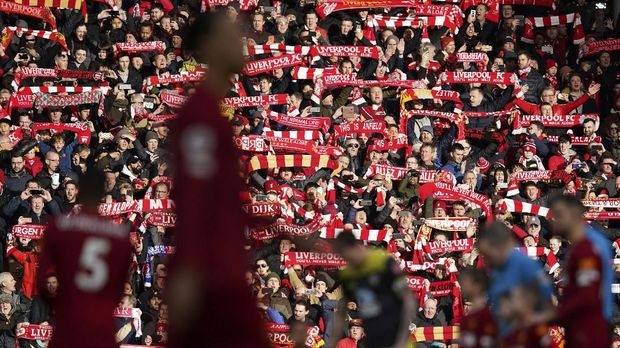 Fans hold up scarfs prior the start of the English Premier League soccer match between Liverpool and Southampton at Anfield Stadium, Liverpool, England, Saturday, February 1, 2020. (AP Photo/Jon Super)