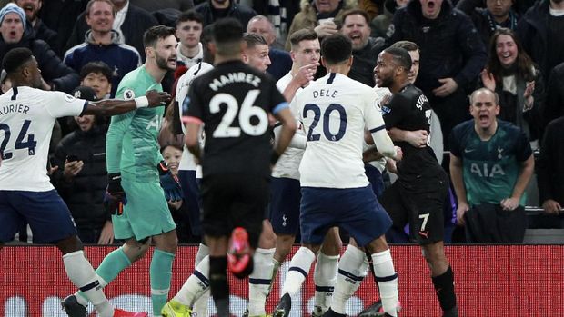 Players argue after Manchester City's Raheem Sterling, right, claimed to have been fouled in the box by Tottenham's goalkeeper Hugo Lloris, 2nd left, during the English Premier League soccer match between Tottenham Hotspur and Manchester City at the Tottenham Hotspur Stadium in London, England, Sunday, Feb. 2, 2020. (AP Photo/Ian Walton)