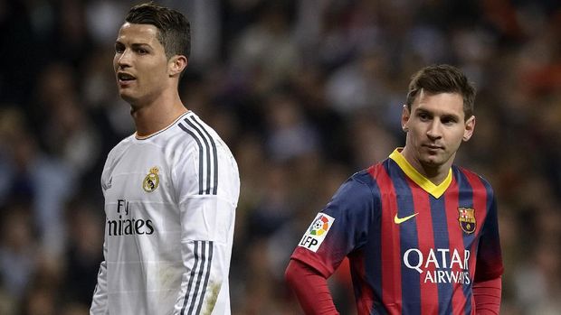 Barcelona's Argentinian forward Lionel Messi (R) stands past Real Madrid's Portuguese forward Cristiano Ronaldo during the 