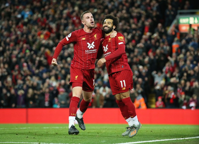 LIVERPOOL, ENGLAND - OCTOBER 27:  Mohamed Salah of Liverpool (11) celebrates as he scores his teams second goal from a penalty with Jordan Henderson during the Premier League match between Liverpool FC and Tottenham Hotspur at Anfield on October 27, 2019 in Liverpool, United Kingdom. (Photo by Jan Kruger/Getty Images)