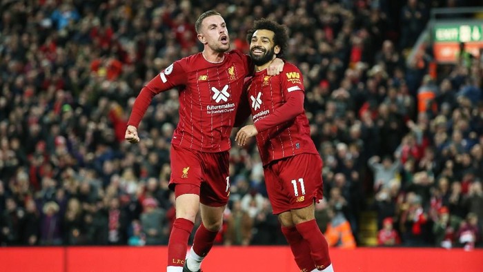 LIVERPOOL, ENGLAND - OCTOBER 27:  Mohamed Salah of Liverpool (11) celebrates as he scores his teams second goal from a penalty with Jordan Henderson during the Premier League match between Liverpool FC and Tottenham Hotspur at Anfield on October 27, 2019 in Liverpool, United Kingdom. (Photo by Jan Kruger/Getty Images)