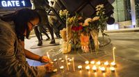 Bunga dan Lilin Hiasi Lokasi Penembakan Brutal di Thailand