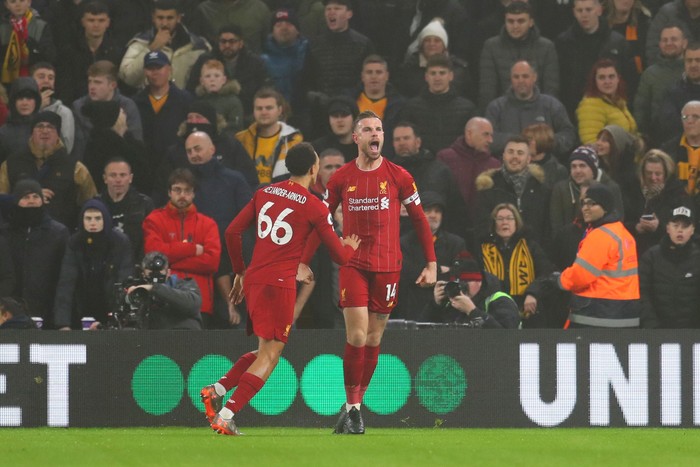 WOLVERHAMPTON, ENGLAND - JANUARY 23:  Jordan Henderson of Liverpool celebrates with team-mate Trent Alexander-Arnold after scoring the opening goal during the Premier League match between Wolverhampton Wanderers and Liverpool FC at Molineux on January 23, 2020 in Wolverhampton, United Kingdom. (Photo by Catherine Ivill/Getty Images)