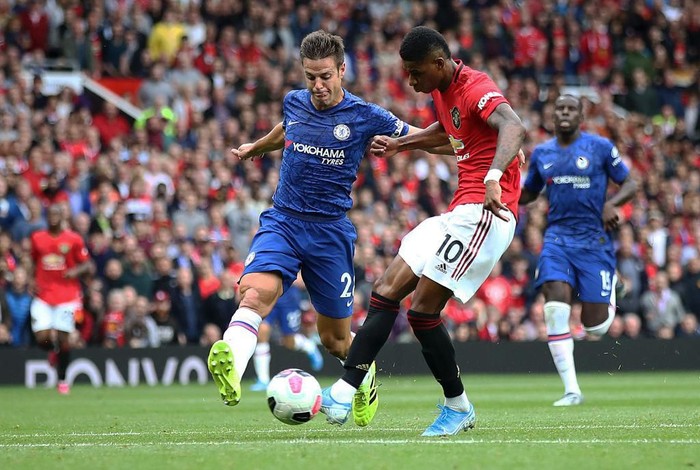 MANCHESTER, ENGLAND - AUGUST 11:  Marcus Rashford of Manchester United scores the third goal during the Premier League match between Manchester United and Chelsea FC at Old Trafford on August 11, 2019 in Manchester, United Kingdom. (Photo by Julian Finney/Getty Images)