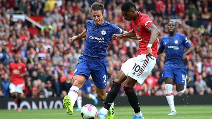 MANCHESTER, ENGLAND - AUGUST 11:  Marcus Rashford of Manchester United scores the third goal during the Premier League match between Manchester United and Chelsea FC at Old Trafford on August 11, 2019 in Manchester, United Kingdom. (Photo by Julian Finney/Getty Images)
