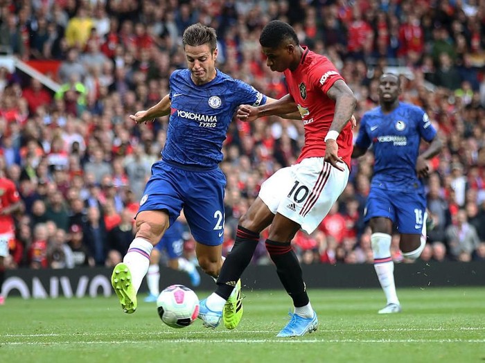 MANCHESTER, ENGLAND - AUGUST 11:  Marcus Rashford of Manchester United scores the third goal during the Premier League match between Manchester United and Chelsea FC at Old Trafford on August 11, 2019 in Manchester, United Kingdom. (Photo by Julian Finney/Getty Images)