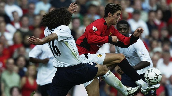 MANCHESTER - AUGUST 16:  Cristiano Ronaldo of Manchester United is challenged by Ivan Campo of Bolton Wanderers during the FA Barclaycard Premiership match held on August 16, 2003 at Old Trafford, in Manchester, England. Manchester United won the match 4-0. (Photo by Alex Livesey/Getty Images)