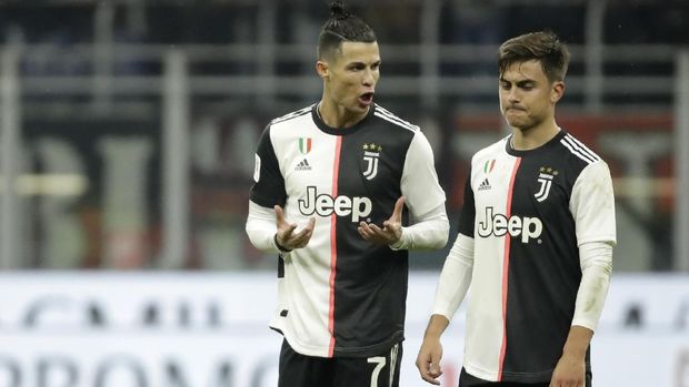 Juventus' Cristiano Ronaldo, left, speaks with Juventus' Paulo Dybala at the end of the Italian Cup soccer match between AC Milan and Juventus at the San Siro stadium, in Milan, Italy, Thursday, Feb. 13, 2020. (AP Photo/Luca Bruno)