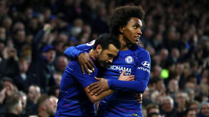 LONDON, ENGLAND - JANUARY 12:  Pedro of Chelsea celebrates with teammate Willian after scoring his teams first goal  during the Premier League match between Chelsea FC and Newcastle United at Stamford Bridge on January 12, 2019 in London, United Kingdom.  (Photo by Clive Rose/Getty Images)