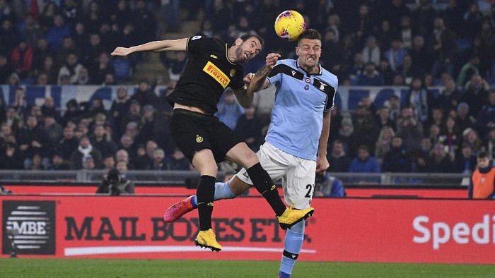 Inter Milan’s Diego Godin and Lazio’s Sergej Milinkovic-Savic jump for the ball during the Serie A soccer match between Lazio and inter Milan, at Romes Olympic stadium, Sunday, Feb. 16, 2020. (Alfredo Falcone/LaPresse via AP)