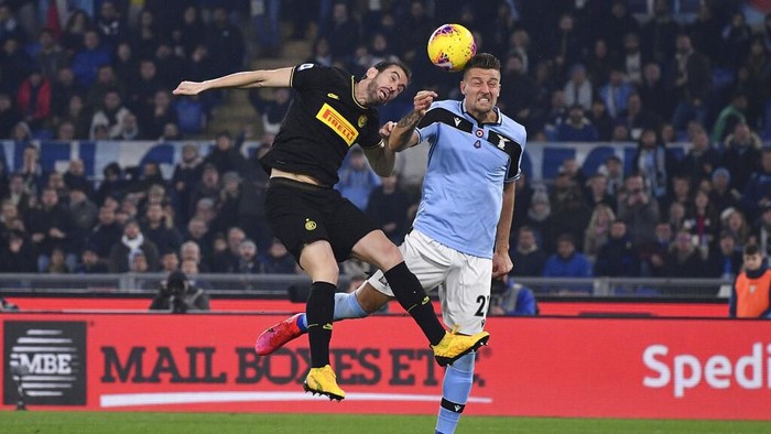 Inter Milan’s Diego Godin and Lazio’s Sergej Milinkovic-Savic jump for the ball during the Serie A soccer match between Lazio and inter Milan, at Romes Olympic stadium, Sunday, Feb. 16, 2020. (Alfredo Falcone/LaPresse via AP)