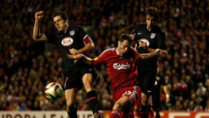 Atletico Madrid vs Liverpool LIVERPOOL, ENGLAND - APRIL 29: Jamie Carragher of Liverpool clears under pressure from Antonio Lopez of Atletico Madrid during the UEFA Europa League Semi-Final Second Leg match between Liverpool and Atletico Madrid at Anfield on April 29, 2010 in Liverpool, England. (Photo by Clive Brunskill/Getty Images)