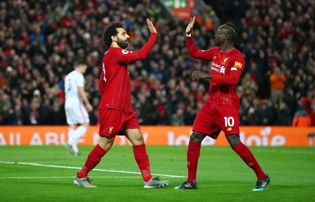 LIVERPOOL, ENGLAND - JANUARY 02: Mohamed Salah of Liverpool celebrates with Sadio Mane after scoring his team's first goal during the Premier League match between Liverpool FC and Sheffield United at Anfield on January 02, 2020 in Liverpool, United Kingdom. (Photo by Clive Brunskill/Getty Images)