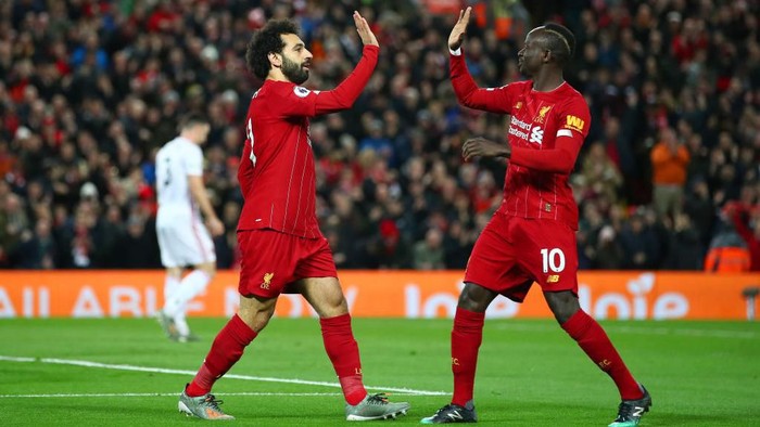 LIVERPOOL, ENGLAND - JANUARY 02: Mohamed Salah of Liverpool celebrates with Sadio Mane after scoring his teams first goal during the Premier League match between Liverpool FC and Sheffield United at Anfield on January 02, 2020 in Liverpool, United Kingdom. (Photo by Clive Brunskill/Getty Images)