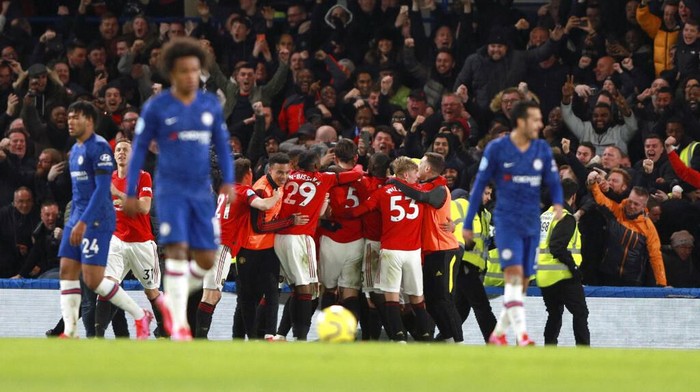 Manchester Uniteds Harry Maguire, 5, is congratulated by teammates after scoring his teams second goal during the English Premier League soccer match between Chelsea and Manchester United at Stamford Bridge in London, England, Monday, Feb. 17, 2020. (AP Photo/Ian Walton)