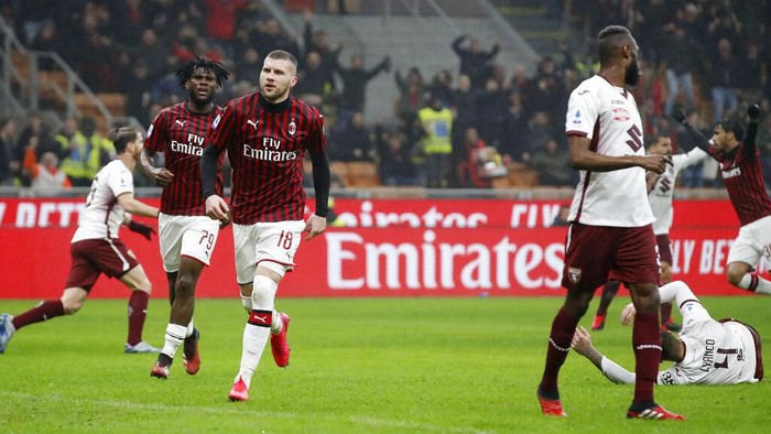 AC Milans Ante Rebic, third from left, celebrates after scoring his sides opening goal during the Serie A soccer match between AC Milan and Torino at the San Siro stadium, in Milan, Italy, Monday, Feb. 17, 2020. (AP Photo/Antonio Calanni)