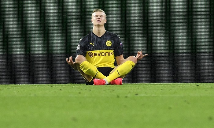 Dortmunds Erling Braut Haaland poses after scoring his first goal during the Champions League round of 16 first leg soccer match between Borussia Dortmund and Paris Saint Germain in Dortmund, Germany, Tuesday, Feb. 18, 2020. (AP Photo/Martin Meissner)