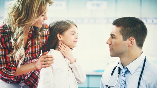 Little girl using nebulizer during inhaling therapy.