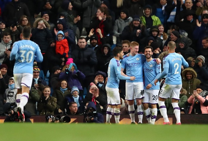 MANCHESTER, ENGLAND - FEBRUARY 19: Kevin De Bruyne of Manchester City celebrates with Bernardo Silva of Manchester City  after scoring his teams second goal  during the Premier League match between Manchester City and West Ham United at Etihad Stadium on February 19, 2020 in Manchester, United Kingdom. (Photo by Clive Brunskill/Getty Images)