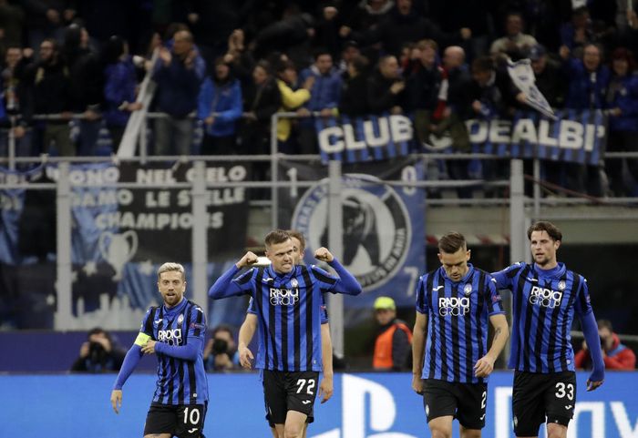 Atalantas Josip Ilicic, second left, celebrates with teammates after scoring his sides second goal during the Champions League round of 16, first leg, soccer match between Atalanta and Valencia at the San Siro stadium in Milan, Italy, Wednesday, Feb. 19, 2020. (AP Photo/Luca Bruno)