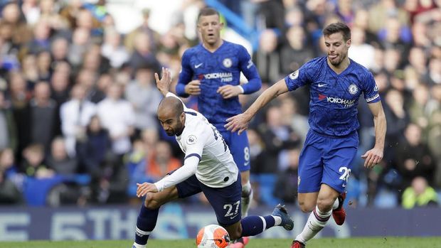 Tottenham Hotspur's Lucas Moura falls while running with the ball during their English Premier League soccer match against Chelsea in London, England, Saturday, Feb. 22, 2020. (AP Photo/Kirsty Wigglesworth)