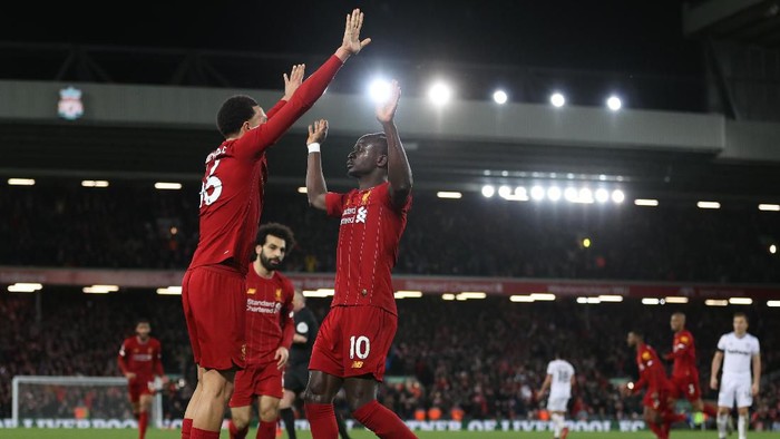 LIVERPOOL, ENGLAND - FEBRUARY 24: Sadio Mané of Liverpool celebrates after scoring his sides third goal with Trent Alexander-Arnold of Liverpool during the Premier League match between Liverpool FC and West Ham United at Anfield on February 24, 2020 in Liverpool, United Kingdom. (Photo by Clive Brunskill/Getty Images)