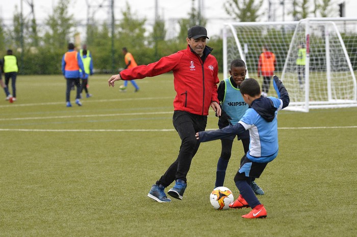 PARIS, FRANCE - MAY 10: Youri Djorkaeff plays with children during to the UEL Trophy Tour Driven by Kia on May 10, 2019 in Paris, France. (Photo by Aurelien Meunier/Getty Images for Kia)