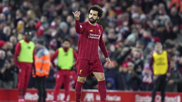 Liverpool's Mohamed Salah reacts after scoring his team's second goal during the English Premier League soccer match between Liverpool and West Ham at Anfield Stadium in Liverpool, England, Monday, Feb. 24, 2020. (AP Photo/Jon Super)