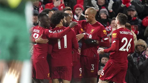 Liverpool players celebrate their first goal during the English Premier League soccer match between Liverpool and West Ham at Anfield Stadium in Liverpool, England, Monday, Feb. 24, 2020. (AP Photo/Jon Super)