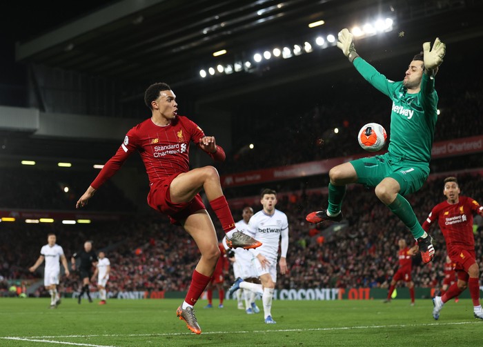 LIVERPOOL, ENGLAND - FEBRUARY 24: Trent Alexander-Arnold of Liverpool passes the ball past Łukasz Fabiański of West Ham United for Sadio Mané of Liverpool to scores his sides third goal during the Premier League match between Liverpool FC and West Ham United at Anfield on February 24, 2020 in Liverpool, United Kingdom. (Photo by Clive Brunskill/Getty Images)